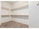 Walk-in closet with built-in shelving and carpeted floor at 41804 W Carlisle Ln, Maricopa, AZ 85138