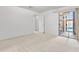 A carpeted bedroom with a sliding glass door leading to an outdoor patio at 420 W Yukon Dr # 4, Phoenix, AZ 85027