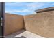Private stucco walled patio with concrete flooring and a bright sky at 420 W Yukon Dr # 4, Phoenix, AZ 85027