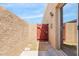 Small private backyard patio with wooden gate and side entrance at 420 W Yukon Dr # 4, Phoenix, AZ 85027