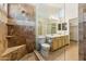 Bathroom with a spacious shower featuring unique stone accents and a double sink at 4202 E Brookwood Ct, Phoenix, AZ 85048