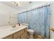 Bathroom features a sink, toilet, mirror, and a tub with a shower curtain at 4202 E Brookwood Ct, Phoenix, AZ 85048