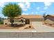 Charming single-story home featuring a well-manicured front yard with mature trees and a cozy desert landscape at 4202 E Brookwood Ct, Phoenix, AZ 85048