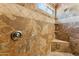 Close-up of a shower featuring unique stone accents and built-in shelving for toiletries at 4202 E Brookwood Ct, Phoenix, AZ 85048