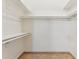 A walk-in closet features built-in shelving and hanging rods for organized storage solutions at 4202 E Brookwood Ct, Phoenix, AZ 85048