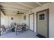 Cozy back porch includes a ceiling fan, outdoor furniture, and dart board at 4240 E Bluefield Ave, Phoenix, AZ 85032