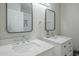 Bathroom featuring double sinks with modern faucets and square mirrors at 4240 E Bluefield Ave, Phoenix, AZ 85032