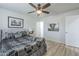 Well-lit bedroom features a ceiling fan, bed with patterned bedding, and an elephant print on the wall at 4240 E Bluefield Ave, Phoenix, AZ 85032