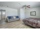 Large bedroom featuring a couch with a ceiling fan and comfortable bed with patterned bedding at 4240 E Bluefield Ave, Phoenix, AZ 85032