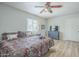 Bright bedroom features wood floors, ceiling fan, television, and closet at 4240 E Bluefield Ave, Phoenix, AZ 85032