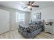 Bright bedroom featuring a ceiling fan and a comfortable bed with stylish gray patterned bedding at 4240 E Bluefield Ave, Phoenix, AZ 85032