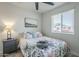 Light-filled bedroom with floral bedding, a nightstand, and a window with a garden view at 4240 E Bluefield Ave, Phoenix, AZ 85032