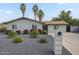Charming single-story home with desert landscaping, palm trees, and mailbox at 4240 E Bluefield Ave, Phoenix, AZ 85032