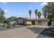 Charming single-story home with desert landscaping, palm trees, and a spacious driveway at 4240 E Bluefield Ave, Phoenix, AZ 85032