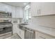 Bright kitchen features stainless steel appliances, white cabinetry, and a subway tile backsplash at 4240 E Bluefield Ave, Phoenix, AZ 85032