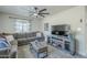 Comfortable living room with plush seating, a ceiling fan, and a modern entertainment center at 4240 E Bluefield Ave, Phoenix, AZ 85032