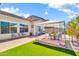 Beautiful backyard with lush artificial grass, patio, and a covered seating area for outdoor enjoyment at 4396 E Austin Ln, San Tan Valley, AZ 85140