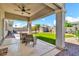 Covered patio with view of the manicured backyard with artificial turf, shed, and water feature at 4396 E Austin Ln, San Tan Valley, AZ 85140