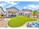 Spacious backyard features lush lawn, covered patio, and desert landscaping for outdoor living at 4396 E Austin Ln, San Tan Valley, AZ 85140