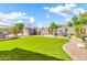 Lush backyard with pristine artificial turf, elegant water feature, and convenient storage shed at 4396 E Austin Ln, San Tan Valley, AZ 85140