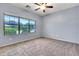 Bedroom showcasing a large window with neighborhood views and neutral carpeting at 4396 E Austin Ln, San Tan Valley, AZ 85140