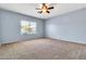 Spacious bedroom with a ceiling fan and large window allowing for natural light at 4396 E Austin Ln, San Tan Valley, AZ 85140
