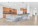 Bright kitchen features a stylish kitchen island with a granite countertop and wooden cabinetry at 4396 E Austin Ln, San Tan Valley, AZ 85140