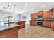 Open kitchen featuring tiled floors, stainless steel appliances, and a breakfast bar at 4396 E Austin Ln, San Tan Valley, AZ 85140