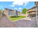 Inviting backyard with a trampoline, swing, artificial grass, and a paver patio at 4408 W Heyerdahl Dr, New River, AZ 85087
