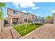 Fenced backyard features artificial grass, trampoline and a swing set at 4408 W Heyerdahl Dr, New River, AZ 85087