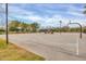 Community basketball court with a covered pavilion, mature trees, and manicured grass at 4408 W Heyerdahl Dr, New River, AZ 85087