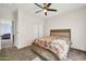 Bright bedroom with a ceiling fan, closet, and a bed with storage drawers at 4408 W Heyerdahl Dr, New River, AZ 85087