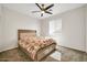 Bright bedroom with a ceiling fan, window, and a bed with storage drawers at 4408 W Heyerdahl Dr, New River, AZ 85087