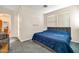 Comfortable bedroom featuring a large bed, carpet flooring, and convenient access to an outdoor area at 4408 W Heyerdahl Dr, New River, AZ 85087