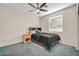 A well-lit bedroom featuring a ceiling fan, carpet, and a full size bed at 4408 W Heyerdahl Dr, New River, AZ 85087