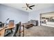 Inviting bonus room with a large desk, comfortable couch, and built-in shelving at 4408 W Heyerdahl Dr, New River, AZ 85087