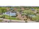 Scenic aerial view of the community park with lake, walking trails, playground, and recreational areas at 4408 W Heyerdahl Dr, New River, AZ 85087