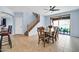 Bright dining area with a wooden table, ceiling fan, tile floor, and sliding door to the backyard at 4408 W Heyerdahl Dr, New River, AZ 85087