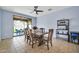 Bright dining room with a large sliding glass door and a dark wooden table at 4408 W Heyerdahl Dr, New River, AZ 85087