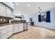 Open concept kitchen with white cabinetry, stainless appliances, and stylish backsplash at 4408 W Heyerdahl Dr, New River, AZ 85087