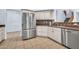 Modern kitchen with stainless steel refrigerator, white cabinets, and tile backsplash at 4408 W Heyerdahl Dr, New River, AZ 85087
