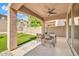 Covered patio with ceiling fan, perfect for outdoor dining and entertaining with a view of the backyard play area at 4408 W Heyerdahl Dr, New River, AZ 85087