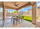 Enjoy outdoor living on this covered patio with dining space and views of the trampoline and swing set at 4408 W Heyerdahl Dr, New River, AZ 85087