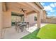 Relaxing covered patio with ceiling fan and outdoor dining area, ideal for enjoying the Arizona weather at 4408 W Heyerdahl Dr, New River, AZ 85087