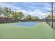Community tennis court features a well-maintained blue surface, benches, and lighting at 4408 W Heyerdahl Dr, New River, AZ 85087