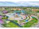 Aerial view of the community waterpark, complete with slides, pools, and colorful shade structures at 4408 W Heyerdahl Dr, New River, AZ 85087