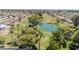 An aerial view of a meticulously maintained golf course with mature trees and a serene water feature at 515 S Parkcrest -- # 531, Mesa, AZ 85206
