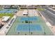 Aerial view of the community tennis and bocce ball courts, featuring pristine landscaping and shade structures at 515 S Parkcrest -- # 531, Mesa, AZ 85206