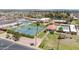 An aerial view of tennis courts, lawn bowling and the community center, featuring lush landscaping and palm trees at 515 S Parkcrest -- # 531, Mesa, AZ 85206