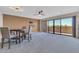 Carpeted living room with dining area and large sliding glass doors to balcony at 515 S Parkcrest -- # 531, Mesa, AZ 85206